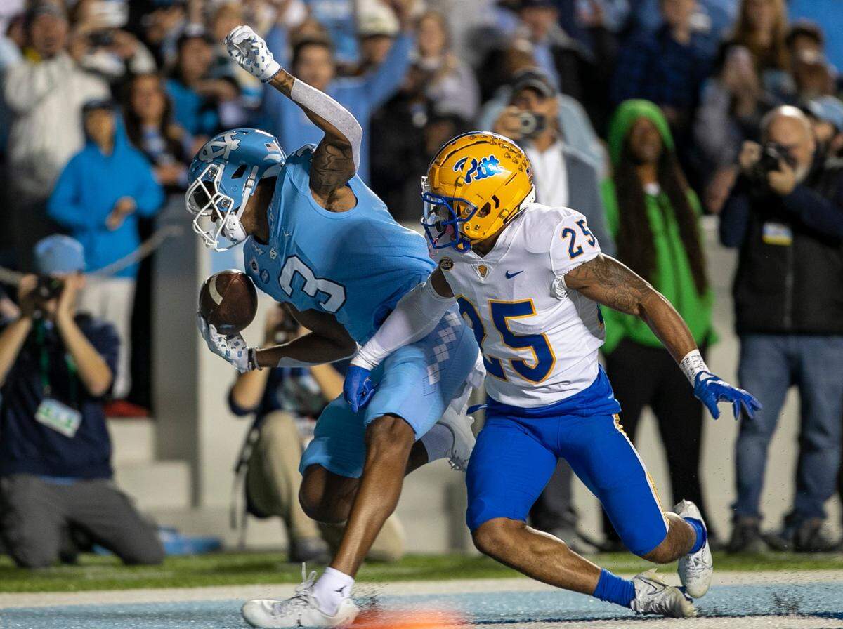 North Carolina’s Antoine Green (3) pulls in a 16-yard pass from quarterback Drake Maye for a touchdown in the first quarter ahead of Pitt’s A.J. Woods (25) on Saturday, October 29, 2022 at Kenan Stadium in Chapel Hill, N.C.