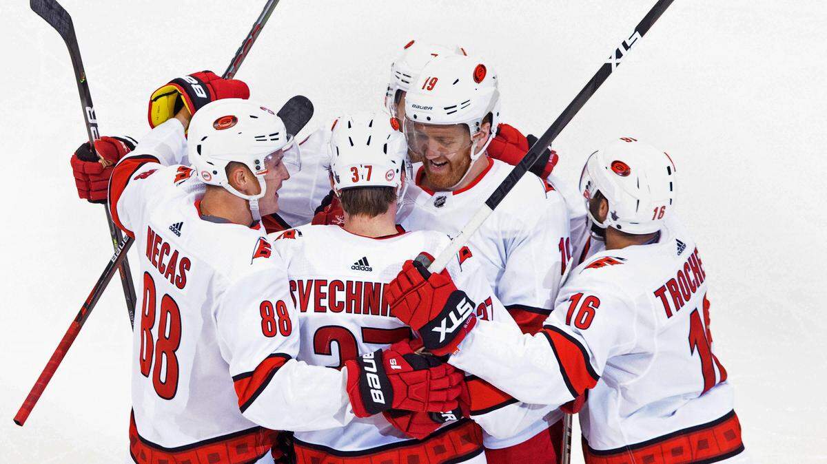 Carolina Hurricanes defenseman Dougie Hamilton (19) celebrates his game-winning goal against the Boston Bruins with teammates Martin Necas (88), Andrei Svechnikov (37) and Vincent Trocheck (16) during the third period of the Hurricanes’ 3-2 win in Toronto, Thursday, Aug. 13, 2020.
