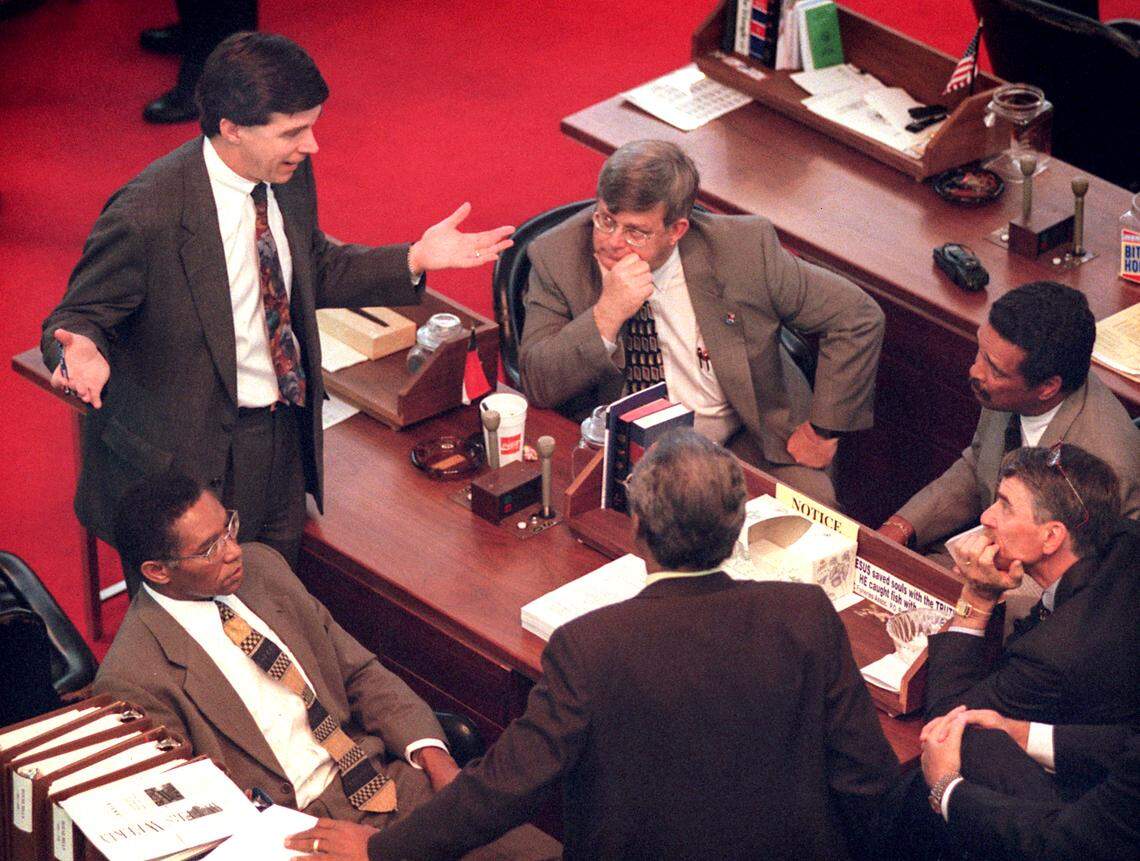 In this May 1998 file photo, then-N.C. Sen. Roy Cooper, left, talks with House members, clockwise from left, Rep. Bob Hensley, Rep. Howard Hunter, Rep. Joe Hackney, Rep. Mickey Michaux and Rep. Dan Blue.