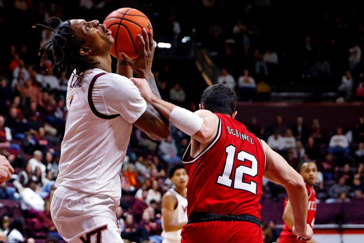Virginia Tech Hokies forward Tobi Lawal (1) is fouled by North Carolina State Wolfpack guard Michael O’Connell (12) during the first half at Cassell Coliseum.