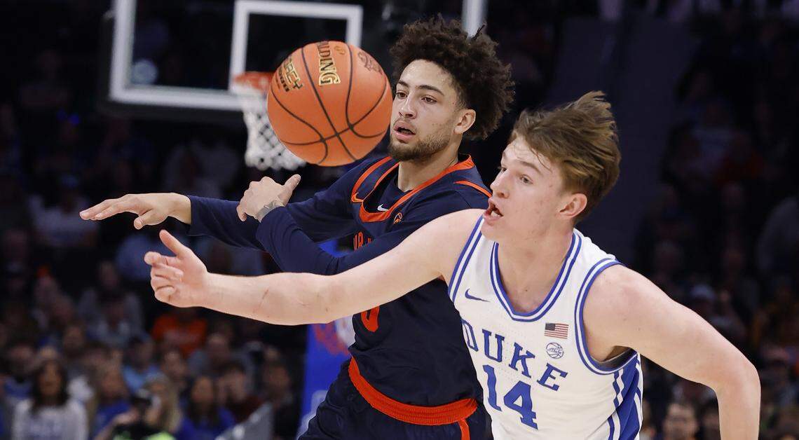 Duke’s Nikolas Khamenia (14) gets to the ball before Virginia's Sam Lewis (5) during the first half of Duke’s game against Virginia in the finals of the 2026 ACC Men’s Basketball Tournament at the Spectrum Center in Charlotte, N.C., Saturday, March 14, 2026.