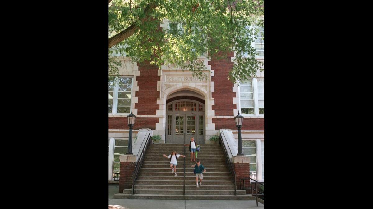 Students leave Wiley Elementary School in Raleigh in this 1998 file photo. A Wiley parent will receive a $1.5 million lawsuit settlement for injuries she suffered in 2015 when she slipped while entering the historic school building.