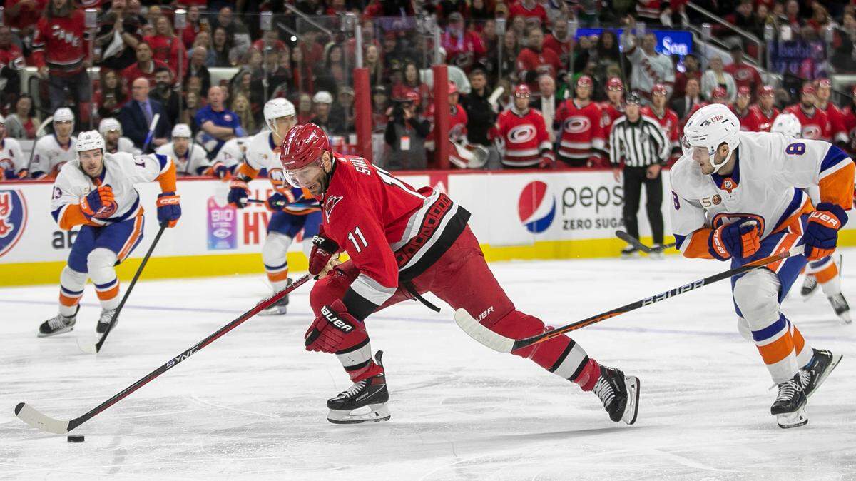 The Carolina Hurricanes Jordan Staal (11) breaks ahead of the New York Islanders Noah Dobson (8) in the first period during Game 5 of their Stanley Cup series on Tuesday, April 25, 2023 at PNC Arena in Raleigh, N.C.