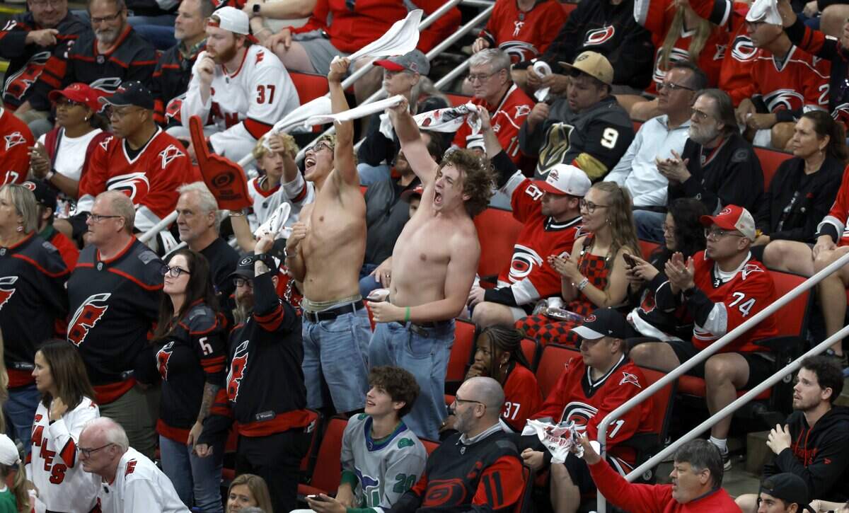 Fans cheer on the Canes in the third period of the Hurricanes’ game against the Golden Knights in the second game of the Stanley Cup Final at the Lenovo Center in Raleigh, N.C., Thursday, June 4, 2026. The “shirtless men cheering” is also known as “tarps off”.