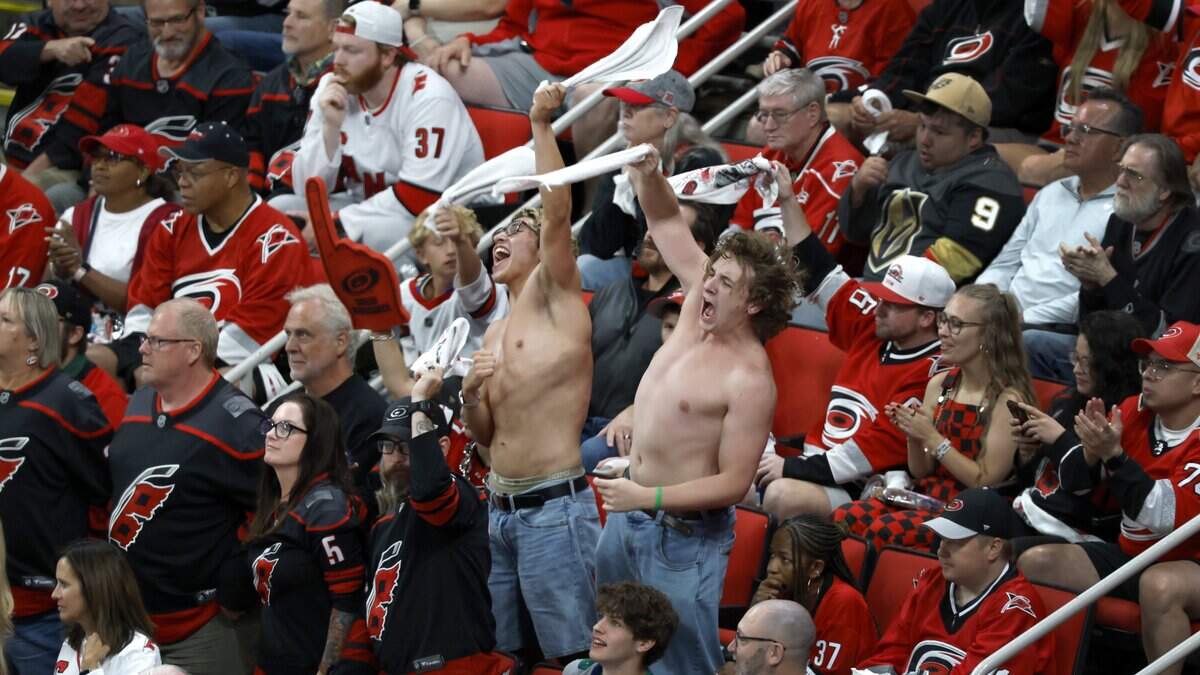 Fans cheer on the Canes in the third period of the Hurricanes’ game against the Golden Knights in the second game of the Stanley Cup Final at the Lenovo Center in Raleigh, N.C., Thursday, June 4, 2026. The “shirtless men cheering” is also known as “tarps off”.