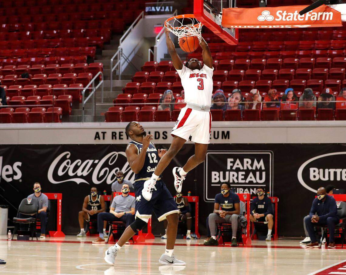 N.C. State’s Cam Hayes (3) slams in two as Charleston Southern’s Ty Jones (12) watches during N.C. State’s game against Charleston Southern in the Wolfpack Invitational at Reynolds Coliseum in Raleigh, N.C., Wednesday, Nov. 25, 2020.
