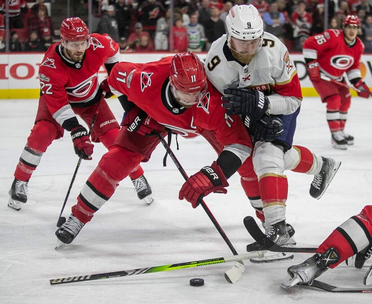 The Carolina Hurricanes Jordan Staal (11) controls a face-off against the Florida Panthers Sam Bennett (9) and his broken stick, during the first overtime period in Game 1 of the Eastern Conference Finals on Thursday, May 18, 2023 at PNC Arena in Raleigh, N.C.