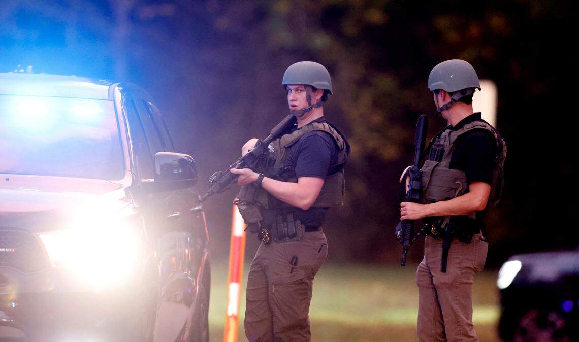 Police stand at the entrance to Neuse River Greenway Trail parking lot at Abington Lane in Raleigh, N.C., Thursday, October 13, 2022.