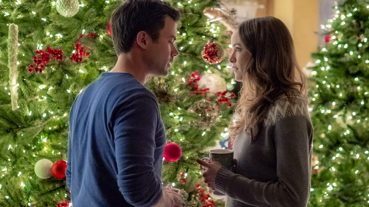 Matt Long, left, and Danielle Panabaker in the Hallmark movie “Christmas Joy.”