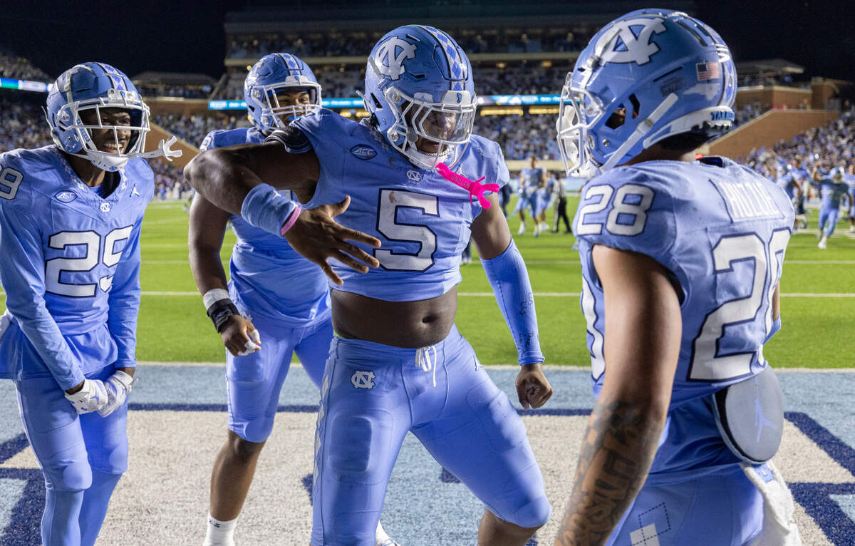 North Carolina’s Marcus Allen (29), Jahvaree Ritzie (5) and Alijah Huzzie (28) celebrate the Tar Heels’ 47-45 double overtime victory over Duke on Saturday, Nov. 11, 2023 at Kenan Stadium in Chapel Hill, N.C.