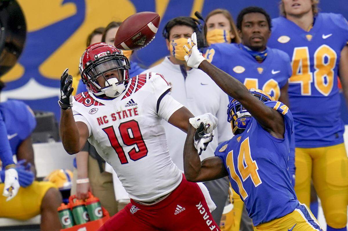 Pittsburgh Panthers defensive back Marquis Williams (14) deflects a pass to North Carolina State wide receiver C.J. Riley (19) during an NCAA college football game, Saturday, Oct. 3, 2020, in Pittsburgh.