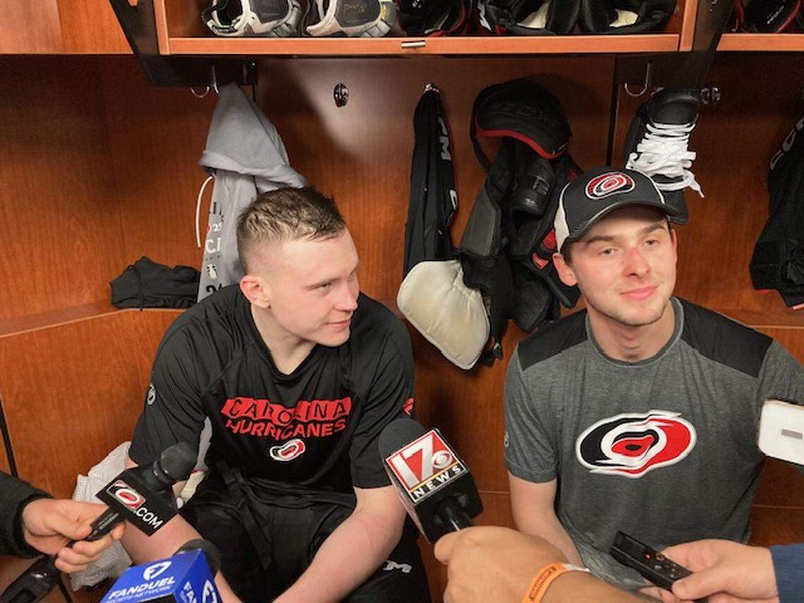 Carolina Hurricanes goalie Pyotr Kochetkov, right, serves as interpreter for defenseman Alexander Nikishin after practice Saturday, April 19, 2025, at Lenovo Center.