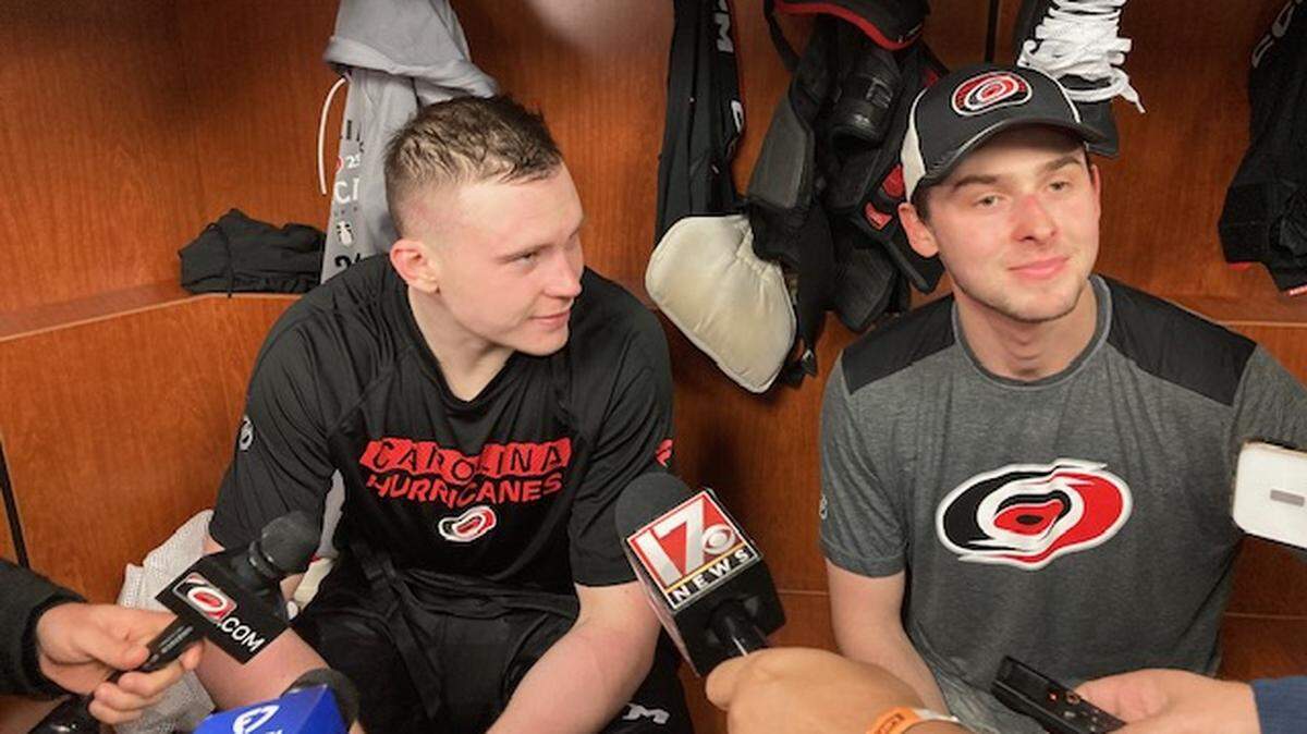 Carolina Hurricanes goalie Pyotr Kochetkov, right, serves as interpreter for defenseman Alexander Nikishin after practice Saturday, April 19, 2025, at Lenovo Center.