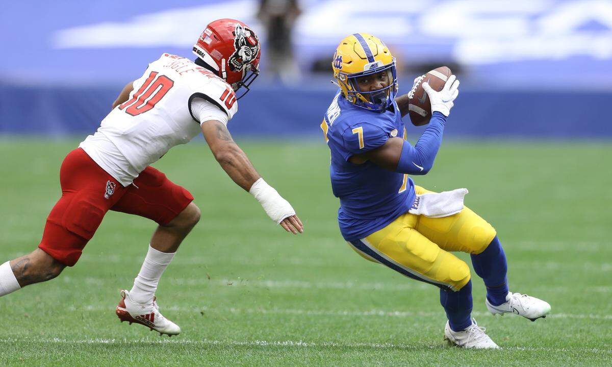 Pittsburgh Panthers wide receiver DJ Turner (7) runs after a catch as N.C. State’s Tanner Ingle (10) purses during the second quarter at Heinz Field.
