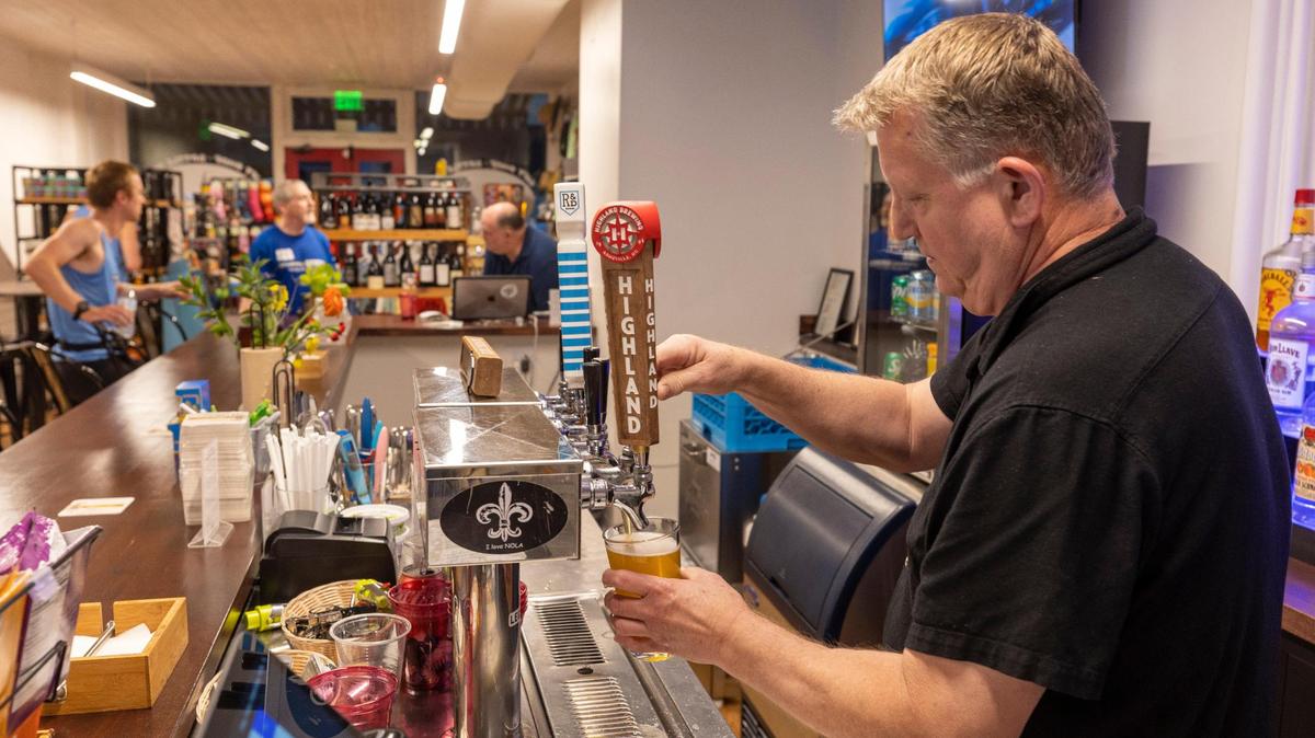 Drew Temple serves a customer at The Green Monkey on Tuesday, September 12, 2023 in Raleigh, N.C.