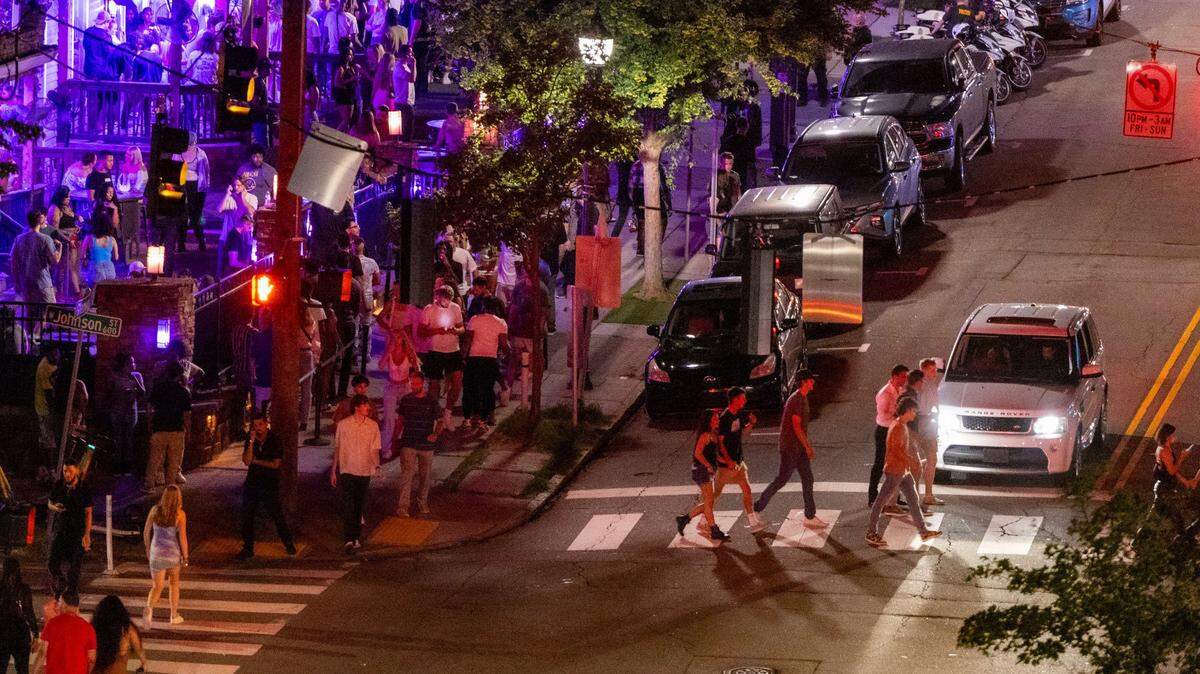 Glenwood Avenue and Cornerstone Tavern bustle with club-goers before 1 a.m. in the Glenwood South district on Friday, July 21, 2023.
