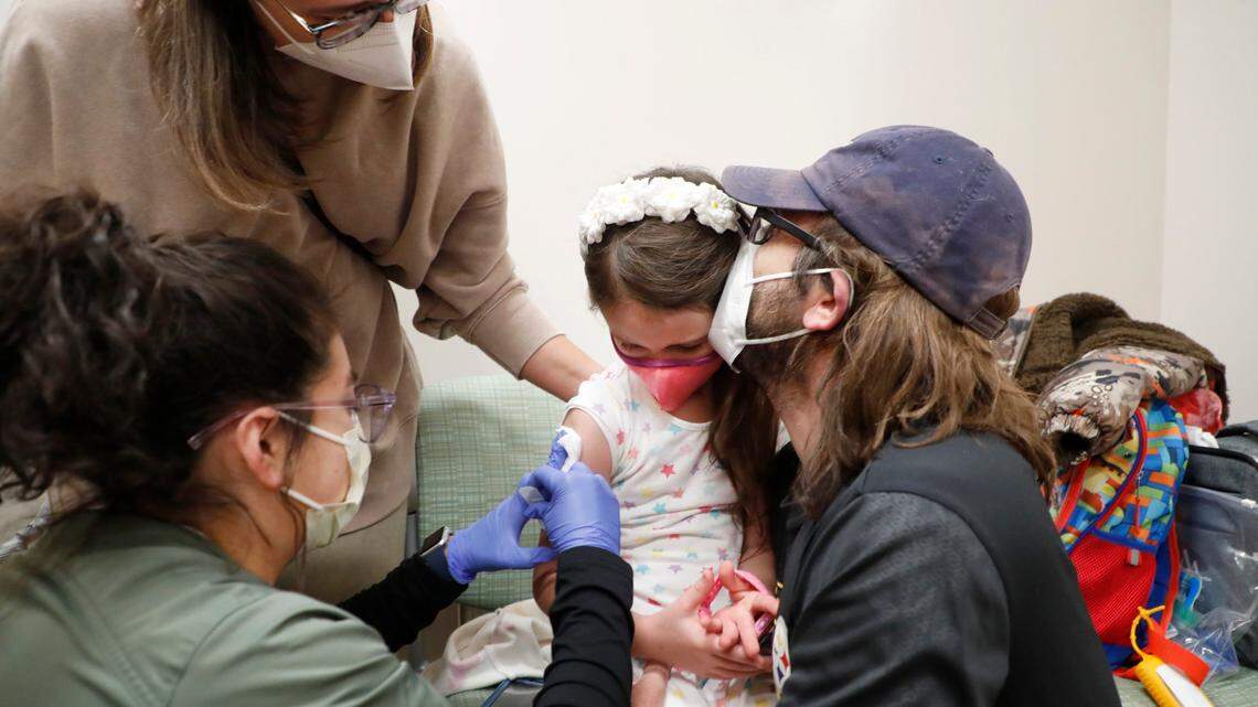 Penelope Washburn, 6, of Holly Springs, gets a kiss from her father Jon after getting her pediatric COVID-19 vaccine shot from Rose Lainez at UNC Childrens clinics in Raleigh, N.C., Thursday, Nov. 4, 2021. Mother Elizabeth, who is to the left, said Thursday was a really big day. The shot gives her kids a chance to be just like kids again.