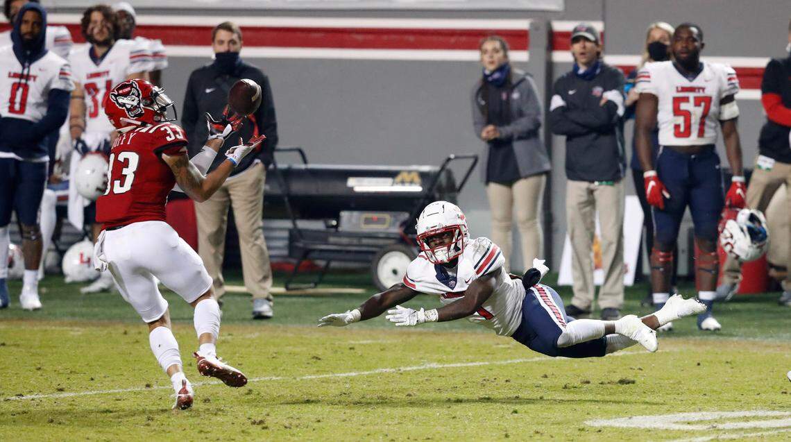 N.C. State cornerback Isaac Duffy (33) intercepts a pass intended for Liberty’s Shedro Louis (1) during the second half of N.C. State’s 15-14 victory over Liberty at Carter-Finley Stadium in Raleigh, N.C., Saturday, Nov. 21, 2020.