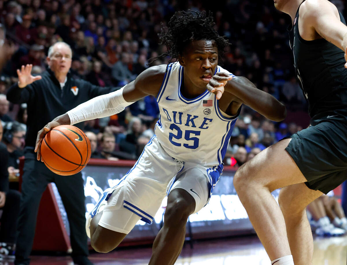 Duke’s Mark Mitchell (25) drives around Virginia Tech’s Grant Basile (21) during the first half of Duke’s game against Virginia Tech at Cassell Coliseum in Blacksburg, VA., Monday, Jan. 23, 2023.