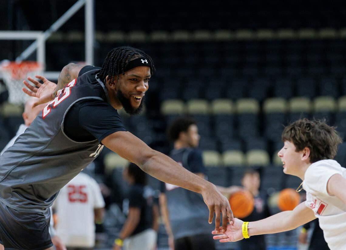 Texas Tech’s Warren Washington high-fives Theo Smart, son of Red Raiders assistant coach Dave Smart, during practice on Wednesday, March 20, 2024, at PPG Paints arena in Pittsburgh, Pa. Washington and N.C. State’s DJ Horne previously played together at Arizona State. N.C. State will face sixth-seeded Texas Tech at 9:40 p.m. on Thursday in Pittsburgh.