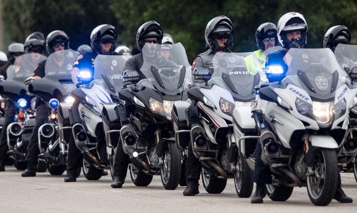 Law enforcement officers prepare to ride ahead of the N.C. State Highway Patrolís Caisson Unit as it carries the casket of slain Wake County Sheriffís Deputy Ned Byrd down Glenwood Avenue on Friday, Aug. 19, 2022, in Raleigh, N.C. Byrd was found dead with multiple gunshot wounds early Friday morning, Aug. 12 in southeastern Wake County.