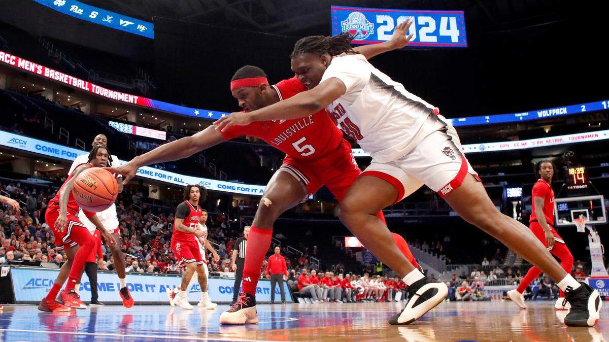 N.C. State’s DJ Burns Jr. (30) and Louisville’s Brandon Huntley-Hatfield (5) go after the ball during N.C. State’s 94-85 victory over Louisville in the first round of the 2024 ACC Men’s Basketball Tournament at Capital One Arena in Washington, D.C., Tuesday, March 12, 2024.