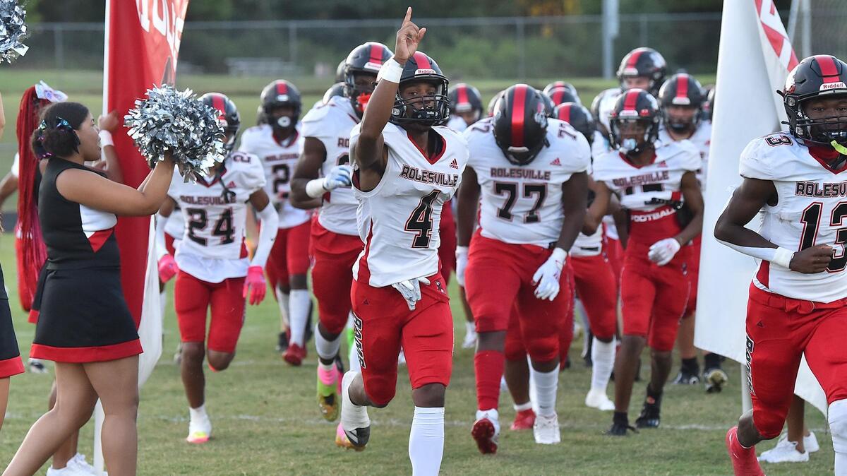 Rolesville’s Dejuan Williams (4) and teammates run onto the field before their game against Durham Hillside. The Durham Hillside Hornets and the Rolesville Rams met in a football game in Durham, N.C. on September 9, 2022.
