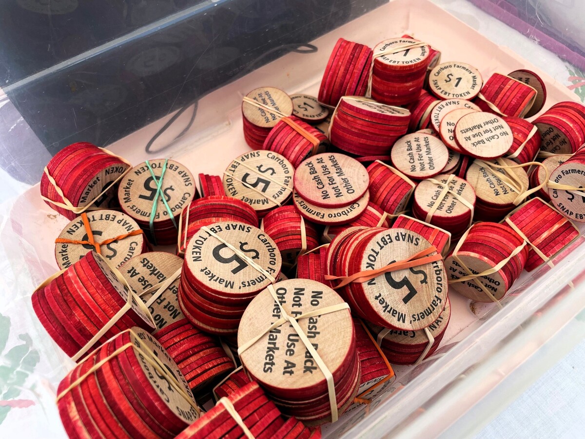 Triangle farmers’ markets added $5 wooden tokens after receiving a $1 million grant from Blue Cross Blue Shield in 2019 and expanding the program so families could get unlimited Double Bucks with their federal food benefits and cash matches.