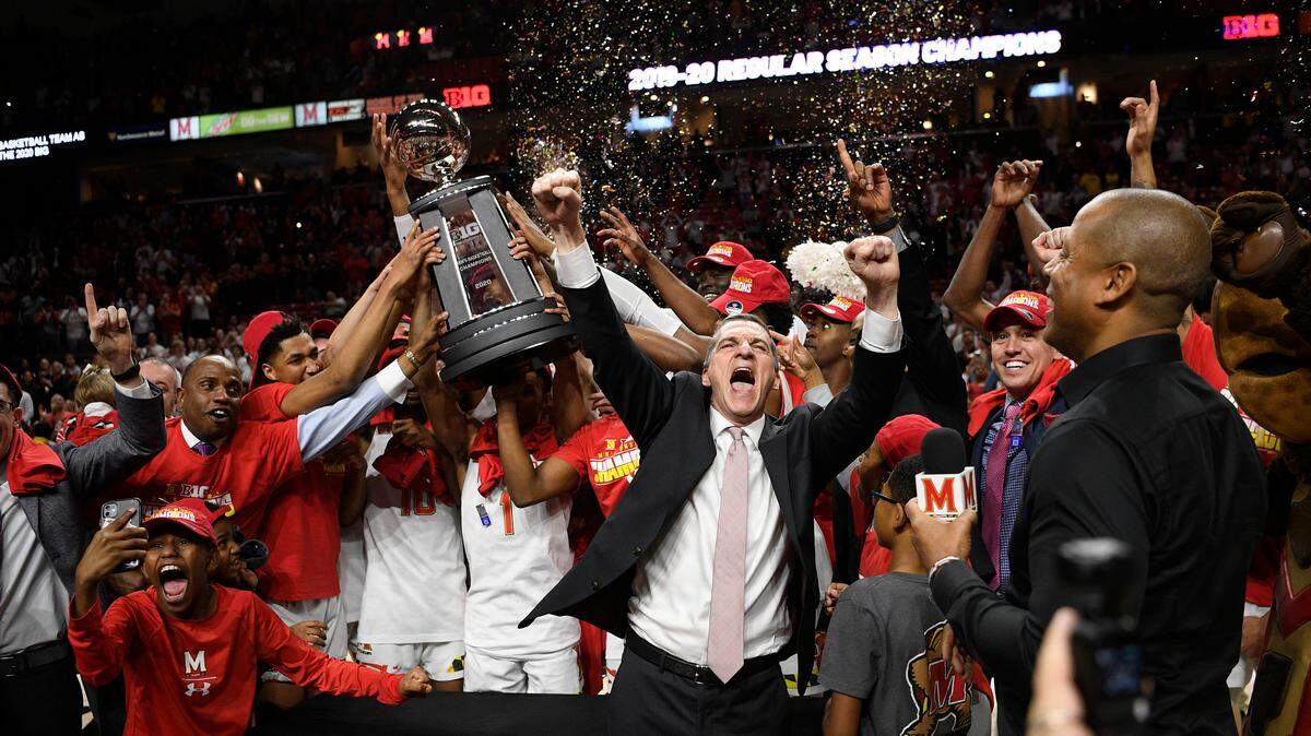 Maryland head coach Mark Turgeon, right center, and his team celebrate after they won a share of the Big Ten regular season title after defeating Michigan in an NCAA college basketball game, Sunday, March 8, 2020, in College Park, Md. Maryland won 83-70. (AP Photo/Nick Wass)