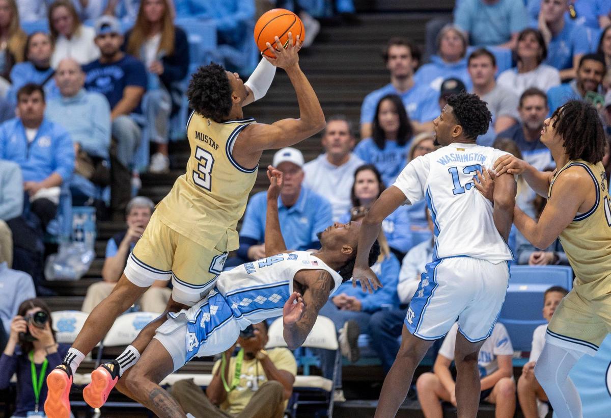 North Carolina North Carolina forward Jae’Lyn Withers (24) draws a charge from Georgia Tech’s Jaeden Mustafa (3) in the second half on Saturday, December 7, 2024 at the Smith Center in Chapel Hill, N.C.
