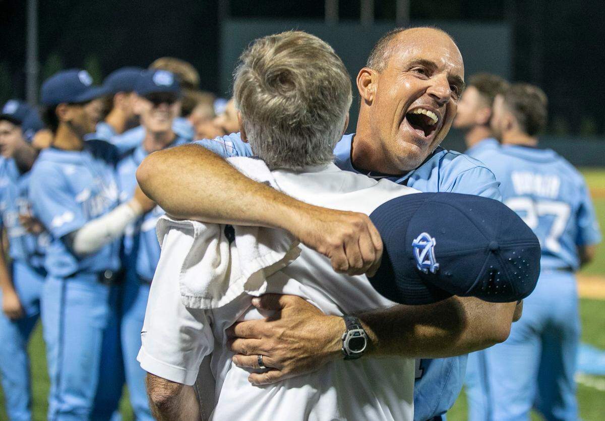 North Carolina coach Scott Forbes embraces Joe Bray following the Tar Heels 7-3 victory over VCU, clinching their NCAA Regional championship on Monday, June 6, 2022 at Boshamer Stadium in Chapel Hill, N.C.