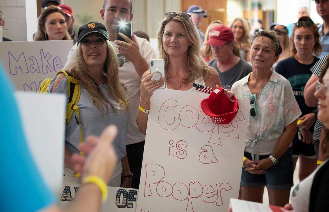 ReopenNC protesters gather at North Carolina House Speaker Tim Moore’s office asking lawmakers to block the mask requirement and to investigate Gov. Roy Cooper’s executive order on Friday, June 26, 2020 in Raleigh, N.C.