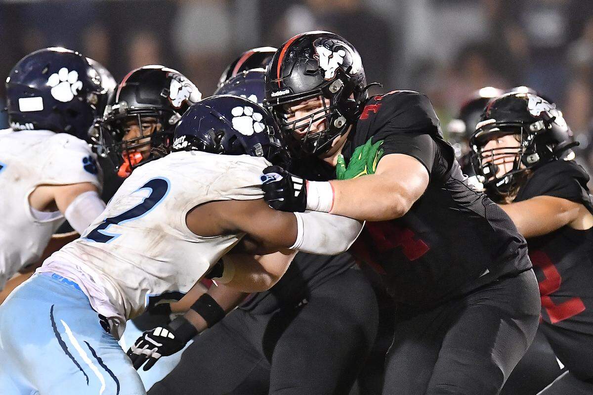 Millbrook defensive tackle Rashad Streets (22) and Rolesville offensive linesman Logan Pulley (74) clash on the line of scrimmage during the second half. The Millbrook Wildcats and the Rolesville Rams met in a conference football game in Rolesville, N.C. September 26, 2025