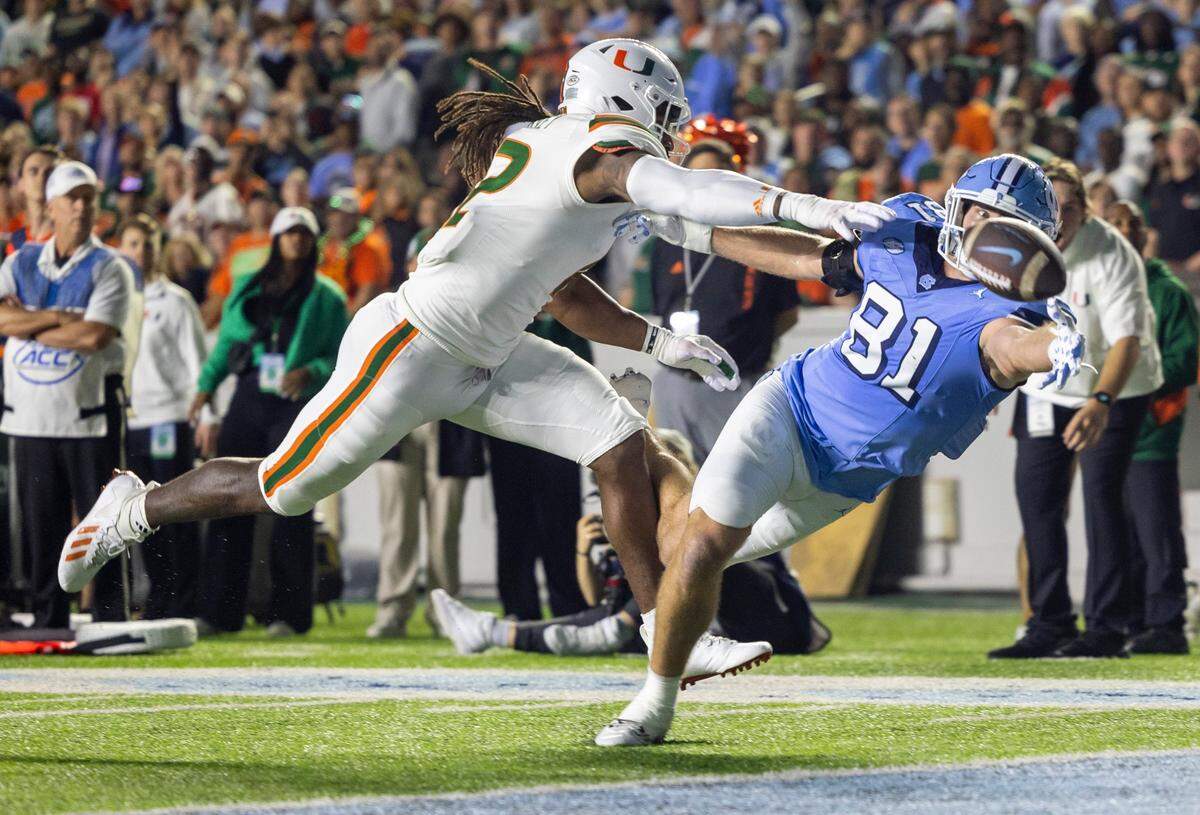 Miami’s Jahfari Harvey (12) defends North Carolina wide receiver John Copenhaver (81) in the end zone during the first quarter on Saturday, October 14, 2023 at Kenan Stadium in Chapel Hill, N.C.
