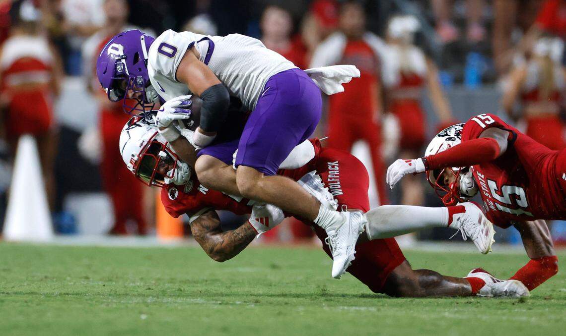 N.C. State safety DK Kaufman (5) tackles Western Carolina wide receiver AJ Colombo (0) during the second half of N.C. State’s 38-21 victory over Western Carolina at Carter-Finley Stadium in Raleigh, N.C., Thursday, August 29, 2024.