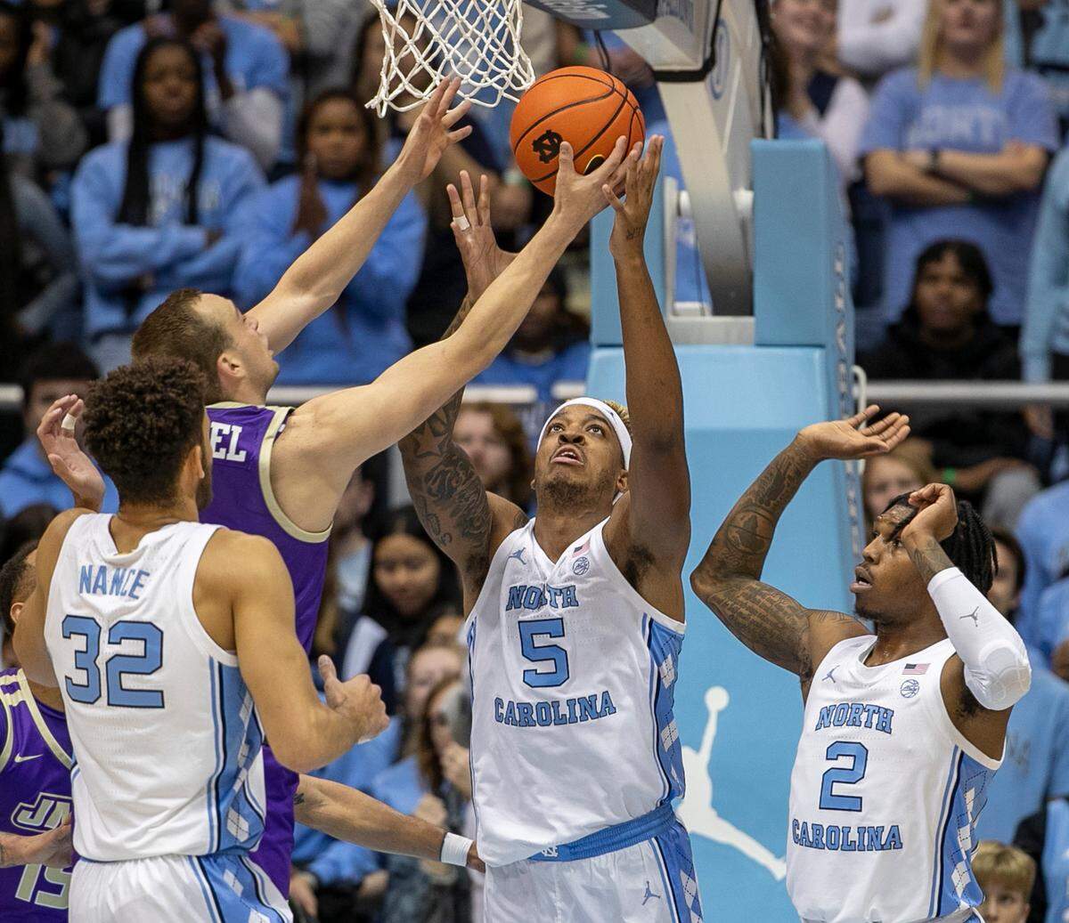 North Carolina’s Armando Bacot (5) battles with James Madison’s Noah Freidel (1) for a defensive rebound in the first half on Sunday, November 20, 2022 at the Smith Center in Chapel Hill, N.C. Bacot had 23 rebounds in the Tar Heels’ victory.