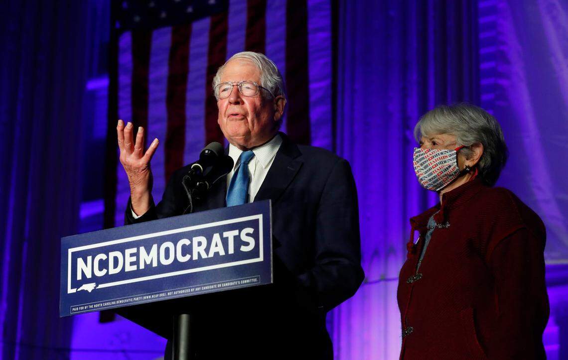 U.S. Rep. David Price speaks outside the North Carolina Democratic Party headquarters in Raleigh, N.C., Tuesday, Nov. 3, 2020. With Price is his wife Lisa.