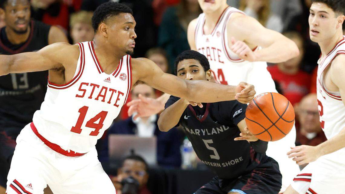 N.C. State’s Casey Morsell (14) steals the ball from Maryland Eastern Shore’s Damani Claxton (5) during the first half of N.C. State’s game against Maryland Eastern Shore at Reynolds Coliseum in Raleigh, N.C., Wednesday, Dec. 6, 2023.