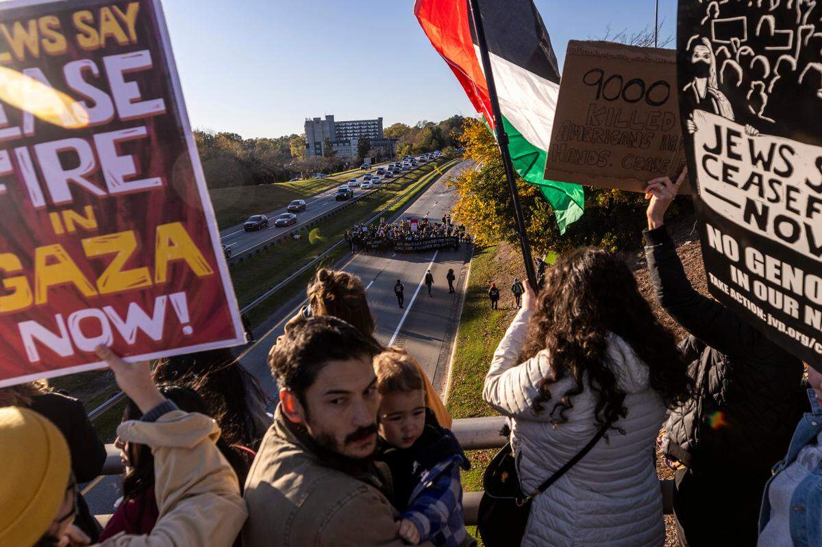Protesters watch from the South Magnum Street bridge as some protesters block the northbound lanes of the Durham Freeway Thursday evening, Nov. 2, 2023. The demonstrators were demanding a ceasefire in the Israel-Gaza War.