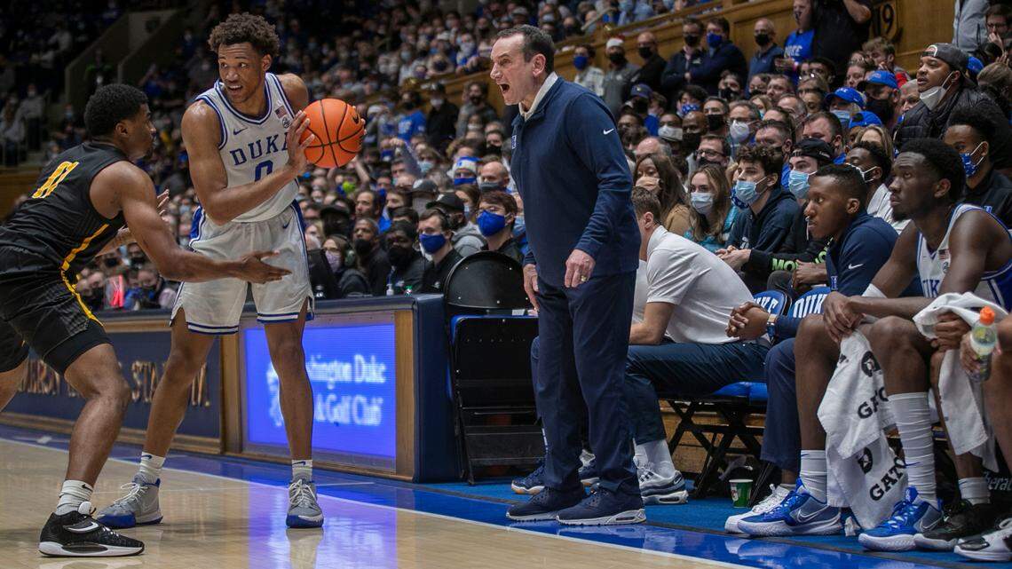 Duke assistant coach Nolan Smith, seated beside head coach Mike Krzyzewski during the Blue Devils’ game against Appalachian State on December 16, 2021, will not be on the bench on Saturday, December 18, 2021, due to NCAA COVID-19 protocols.