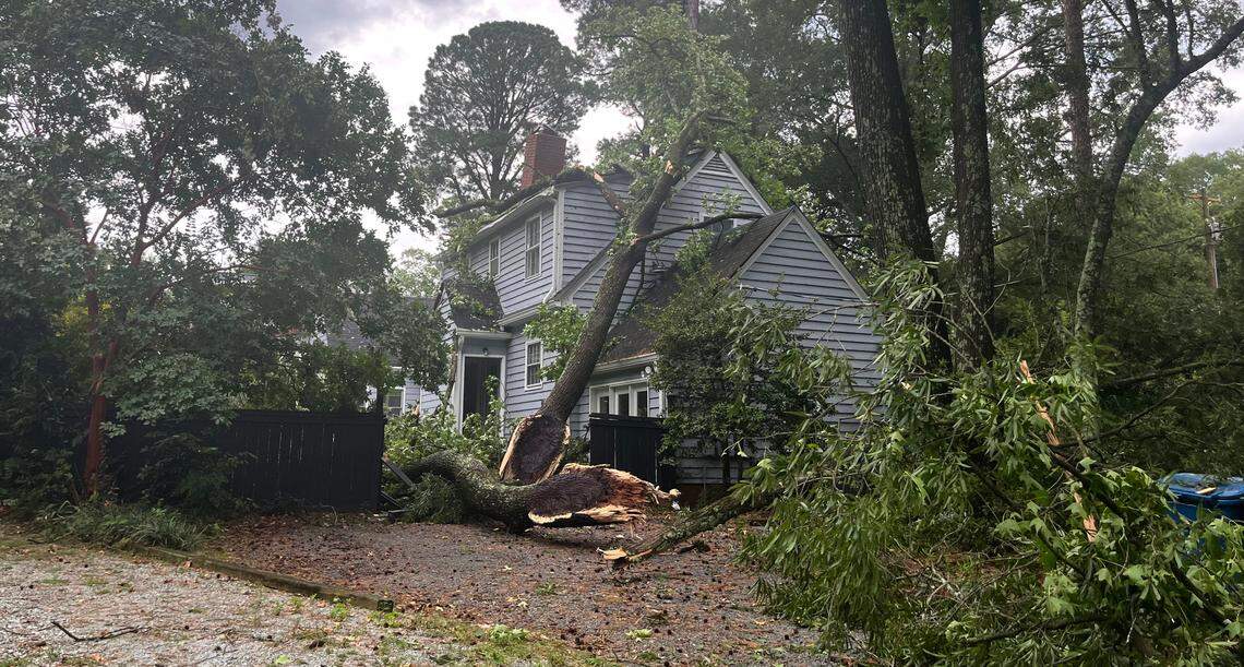 A house is damaged by a tree down at West Club Blvd at Oval Park in Durham, N.C., on Tuesday, August 15, 2023.