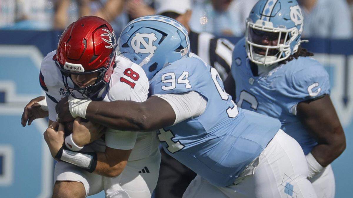 North Carolina defensive lineman Isaiah Johnson (94) tackles Richmond quarterback Ashten Snelsire (18) during the first half of UNC’s game against Richmond at Kenan Stadium in Chapel Hill, N.C., Saturday, Sept. 13, 2025.