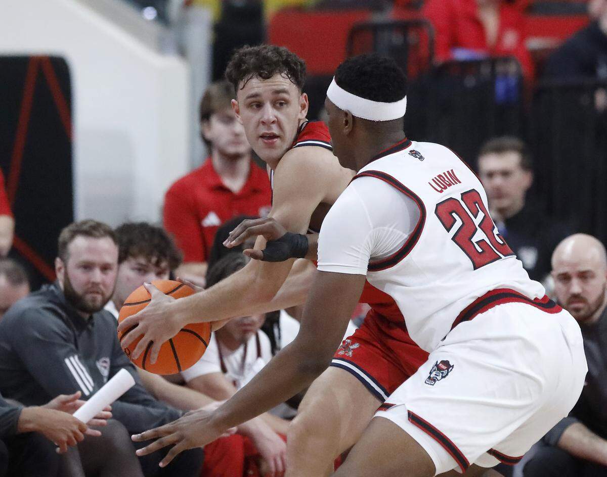 N.C. State’s Ven-Allen Lubin pressures Liberty’s Zach Cleveland during the first half of the Wolfpack’s 85-45 win on Wednesday, Dec. 10, 2025, at Lenovo Center in Raleigh, N.C. 