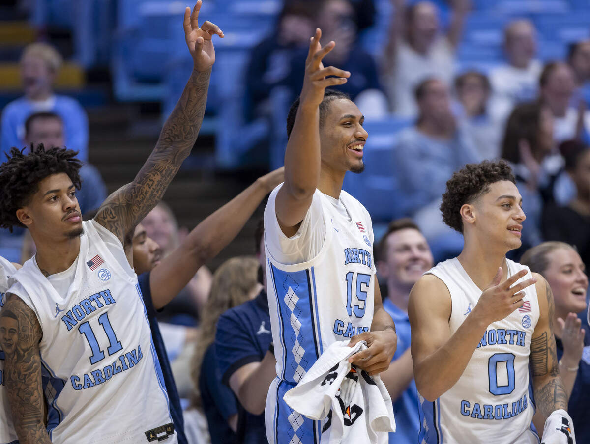 North Carolina guard Jonathan Powell (11), forward Jarin Stevenson (15) and guard Kyan Evans (0) react after a basket by Isaiah Denis (5) in the closing minute of their game against Central Arkansas on Monday, November 3, 2025 at the Smith Center in Chapel Hill, N.C.
