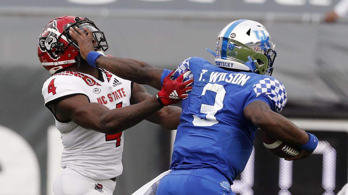 Kentucky quarterback Terry Wilson (3) fights off N.C. State cornerback Cecil Powell (4) during the first half of N.C. State’s game against Kentucky in the Gator Bowl at TIAA Bank Field in Jacksonville, Fla., Saturday, January 2, 2021.