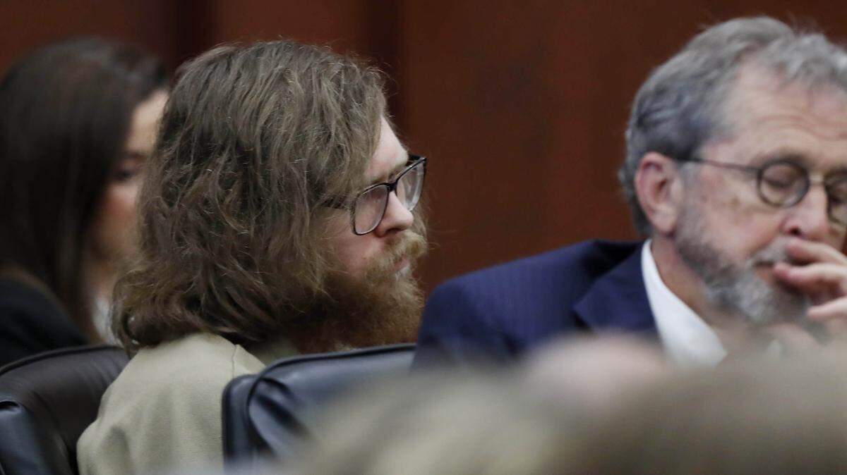 Matthew Phelps (left) listens to victim impact statements  during a hearing Friday, October 5, 2018. Phelps, pleaded guilty to killing his wife Lauren Hugelmaier Phelps.