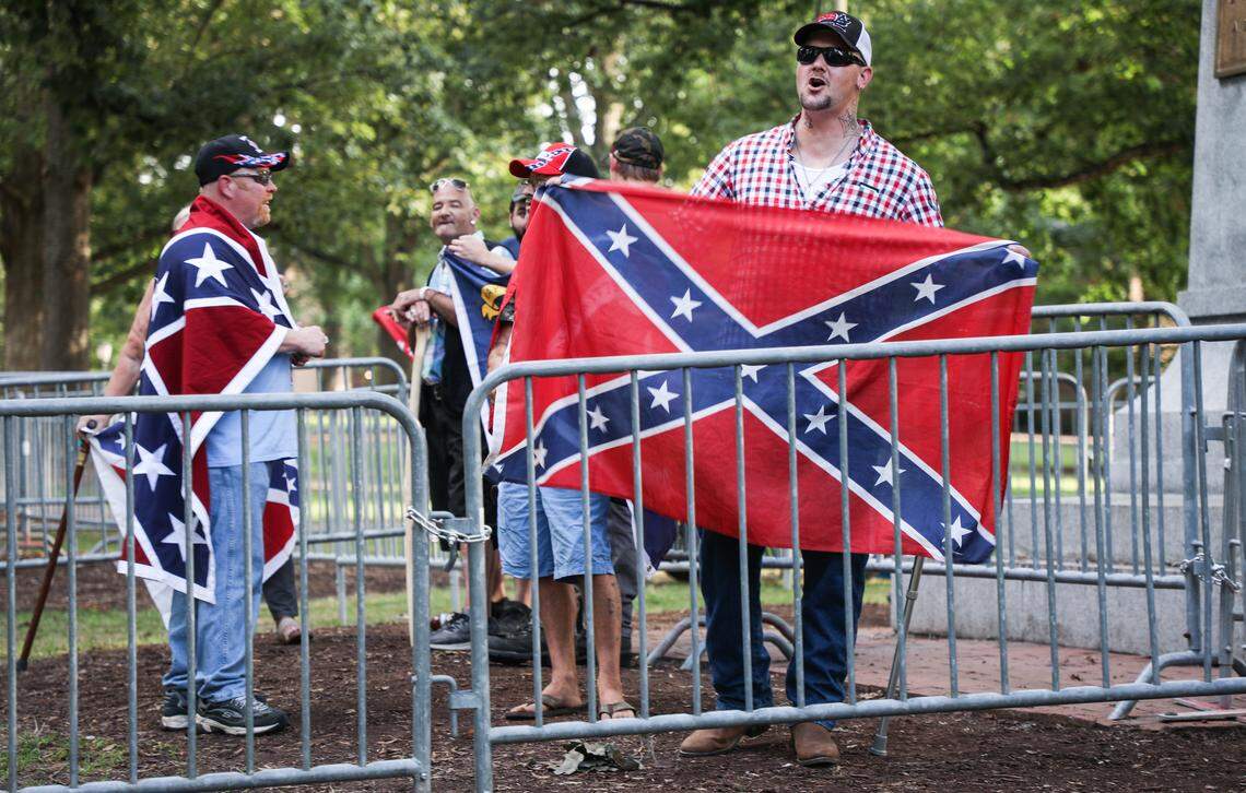 A pro-Confederate demonstrator yells at protesters from behind a barricade on Saturday, September 8, 2018.