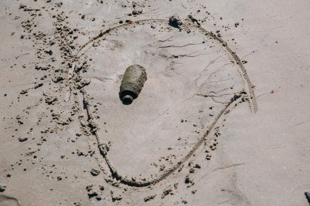 A piece unexploded ordnance is marked on the shore of Browns Island, Marine Corps Base Camp Lejeune, North Carolina, May 14, 2026. Browns Island remains strictly off-limits due to ongoing live-fire training exercises and the presence of dangerous unexploded ordnance. All personnel accessing the island must be accompanied by an explosive ordnance disposal technician due to extreme dangers associated with the high-hazard impact area. For safety reasons, anchoring, disembarking, or engaging in bottom-disturbing activities are strictly prohibited on Browns Island and the surrounding waters. (U.S. Marine Corps photo by Cpl. Daniela Chicas Torres)