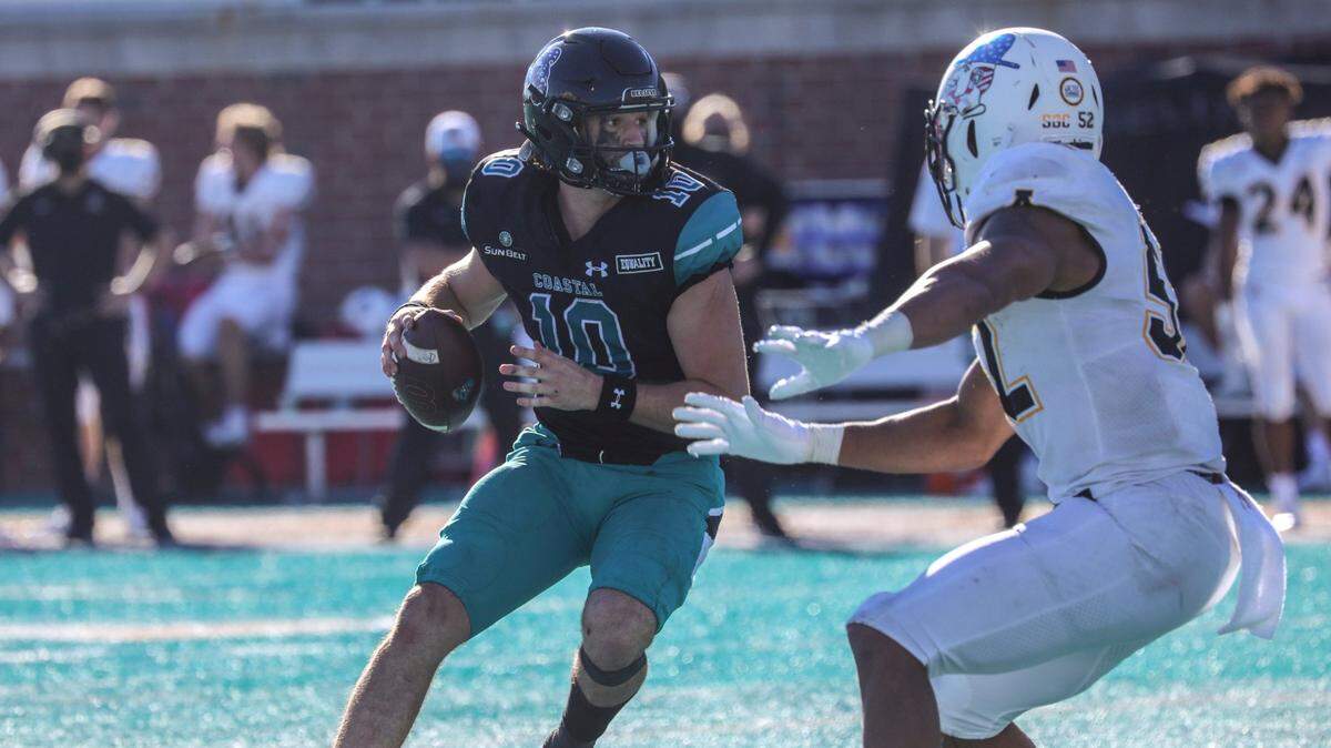 Coastal Carolina quarterback Grayson McCall looks for a receiver under pressure from Appalachian State during last season’s victory in Conway, S.C. Coastal and App State play Wednesday in Boone, N.C.