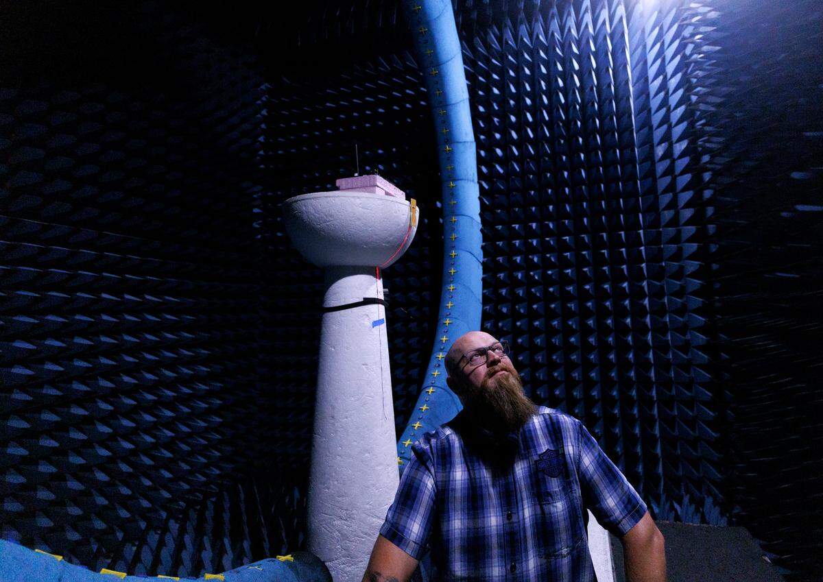 Jordan Stearns, operations manager at the Wireless Research Center of NC, is photographed inside one of the facility’s anechoic chambers in Wake Forest, N.C. on Monday, July 1, 2024. The chamber, which is padded with radio frequency absorber, is used to test equipment.
